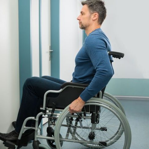 man in wheelchair at a door entryway